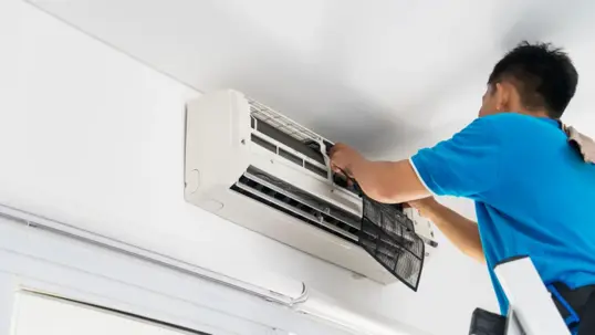 Technician working on an AC unit